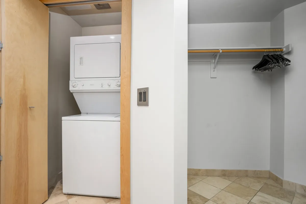 A practical laundry area with a washer and dryer set inside a tidy closet. The setup emphasizes in-unit laundry convenience, supporting longer or more active stays where fresh clothing is needed after outdoor adventures.